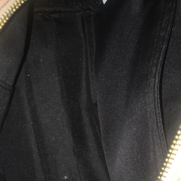 A purse with handles on it’s a peachy color - Picture 2 of 2